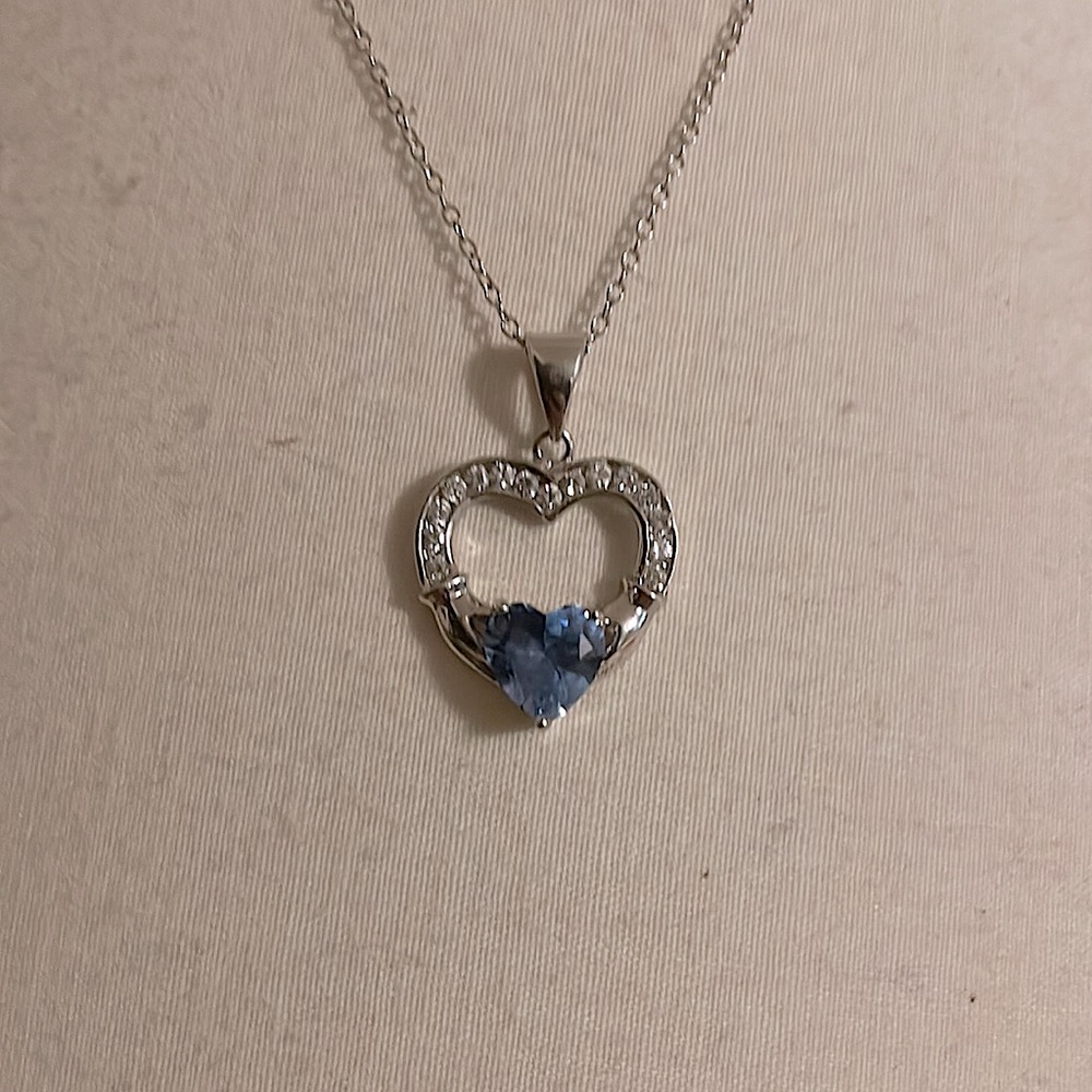 Blue heart in heart shaped necklace.